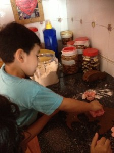 Adam trying out pressing the dough with the cutter.